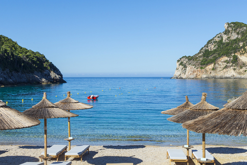 Beautiful view of Agia Triada Beach and its facilities and the beautiful turquoise waters on the island of Corfu, Ionian Islands, Greece