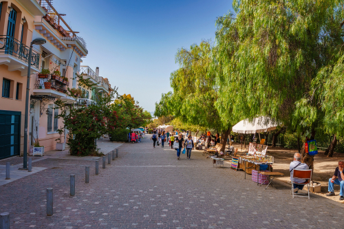 Crowds of people walking on the pedestrian Dionysiou Areopagitou Street. Its the longest walkway in Athens and will seamlessly integrate you into a living open-air museum, Greece