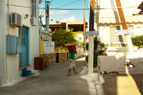 A fisherman carries a fishing tackle on the street of the small fishing town of Elafonisos, Laconia, The Peloponnese, Greece