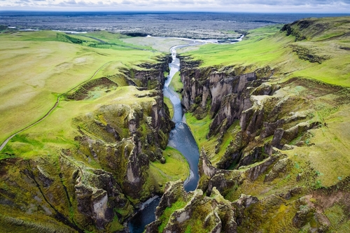 Aerial view beautiful of rugged moss Fjadrargjufur canyon with Fjadra flowing through in summer at Southeast of Iceland