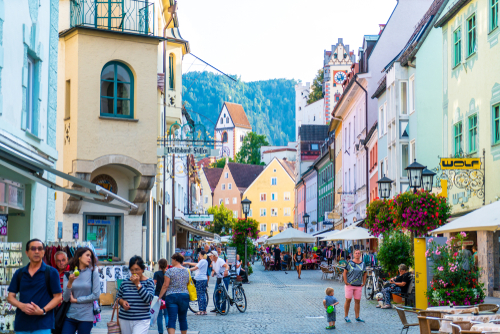 People walking through the streets with restaurants of the Fussen old town city centre, Fussen is a small town in Bavaria, Germany