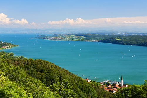 View on Lake Constance (Bodensee) with blue sky and the Alps in background