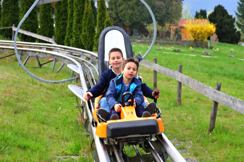 Two Boys at the End of a Dry Toboggan Run near Gutach, Black Forest, Baden-Württemberg, Germany