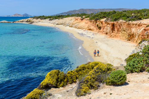 Tourists on Aliko beach, one of the best beaches on the Southwestern side of Naxos Island, Cyclades Islands, Greece. Aliko is a lovely place to relax away from the crowded resorts