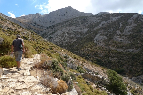 Young man hiking Mount Zas heading towards the Cave of Zas in Naxos island, Cyclades Islands, Greece