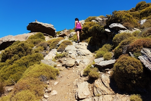 Woman hiking Mount Zas heading towards the Cave of Zas in Naxos island, Cyclades Islands, Greece