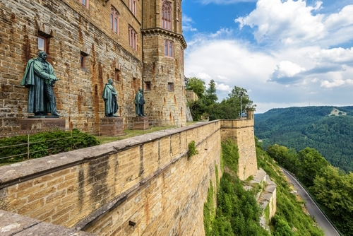Hohenzollern Castle on mountain top, landmark of The Black Forest, Baden-Wurttemberg, Germany. Scenery of statues, fortress wall and sky in Summer