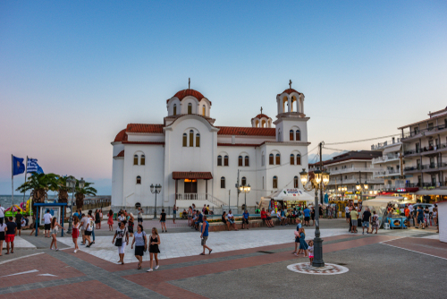 Scenic view of the seaside town Paralia Katerini near the Olympic Coast with people walking walking around a main square, Pieria, Macedonia, Greece