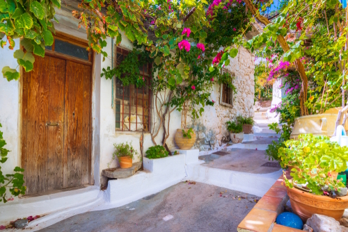 Beautiful view of traditional Cretan village of Kritsa with narrow alleys and houses with bougainvilleas, near Agios Nikolaos, Crete Island, Greece