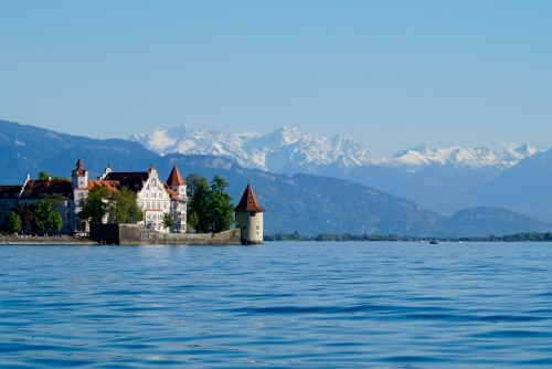 Beautiful island of Lindau on lake Constance (Bodensee) with the snowy Swiss Alps in the background, Germany on fine Sunny Spring day