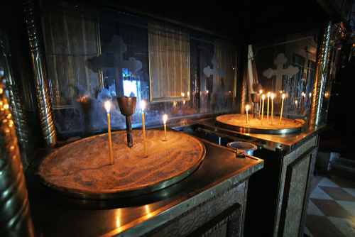 Lighted candles in the monastery of the Virgin Mary in Paleokastritsa, on the Island of Corfu, Greece