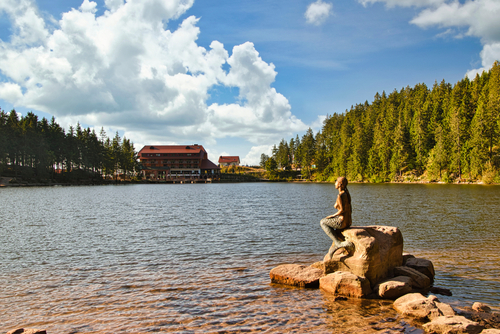Beautiful view of Lake Mummelsee with a sculpture of a mermaid in the foreground, The Black Forest, Baden-wuerttemberg, Germany