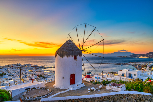 View of a traditional Greek windmill at Sunset on Mykonos Island, Cyclades Islands, Greece