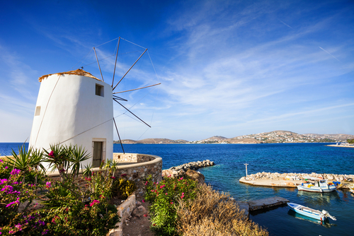 View of a windmill and the coast from Parikia town on the Island of Paros, Cyclades Islands, Greece