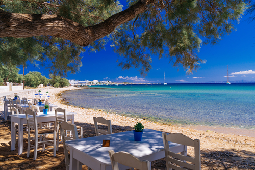 View of a cute little tavern in the olive shade on a beach on Paros Island, Cyclades Islands, Greece