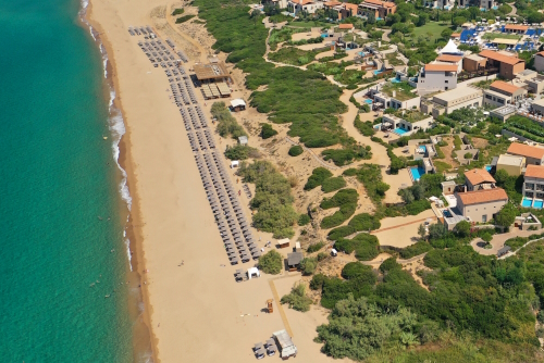 Aerial view of the famous sandy deep turquoise beach and its facilities, and the famous luxury paradise resort of Costa Navarino in the Bay of Navarino, Messinia, Peloponnese, Greece