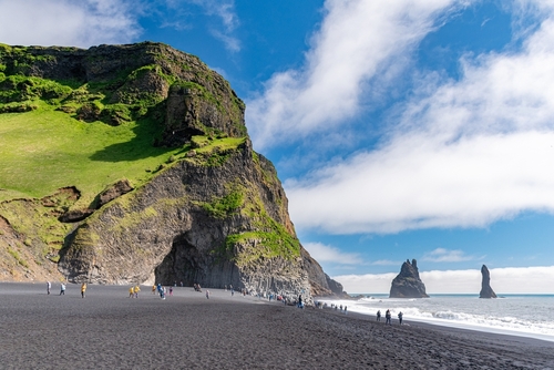 View of Reynisfjara Black Beach and basalt rock formations in the background, Vik, southern Island