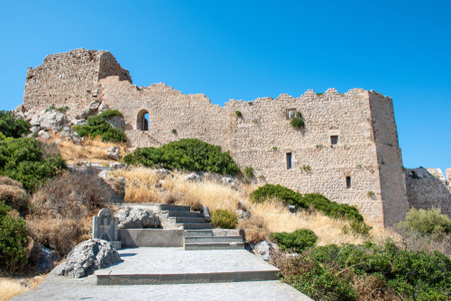 Stairs through bushes to ruins of medieval castle Kritinia on the Island of Rhodes, Greece