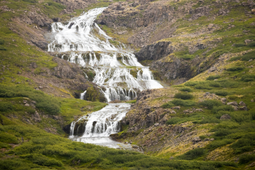 View of Rjukandi waterfalls also called Yst i-Rjukandi with cliffs and waterfalls in Eastern Iceland