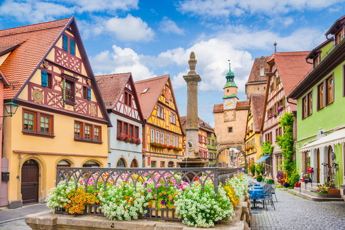Beautiful postcard view of the famous historic town of Rothenburg ob der Tauber on a sunny day with blue sky and clouds in Summer, Franconia, Bavaria, Germany
