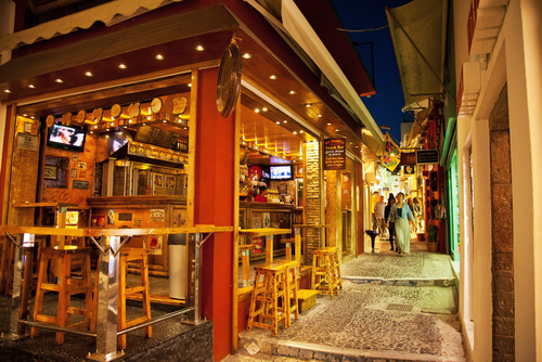 People walking in the streets of Fira in the evening, pubs and shops are open and ready to serve, Santorini Island, Cyclades Islands, Greece