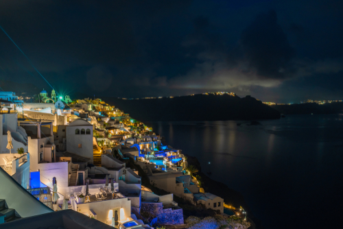 Santorini landscape with night view of whitewashed houses in Oia, Santorini Island, Cyclades Islands, Greece