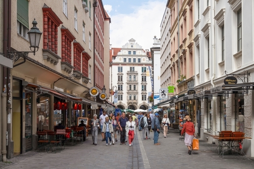 Cozy busy street with the Orlando-Haus in the background, a well-known beer hall and restaurant in the center of Munich, Bavaria, Germany