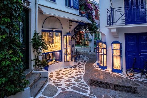 Beautiful old, narrow cobblestone-alley in Skiathos Town during dusk on the Island of Skiathos, Sporades Islands, Greece