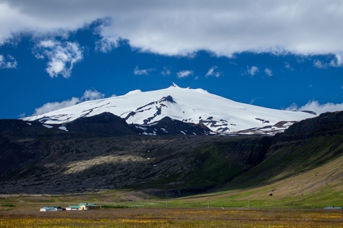 The glacier and volcano Snæfellsjökull towers with its white crown over the outer peninsula of Snæfellsnes in Western Iceland