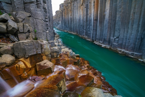 Amazing view of Stuðlagil Canyon, a turquoise waters river between basalt columns in north Iceland