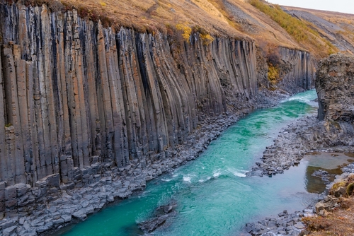Amazing view of Stuðlagil Canyon, a turquoise waters river between basalt columns in north Iceland