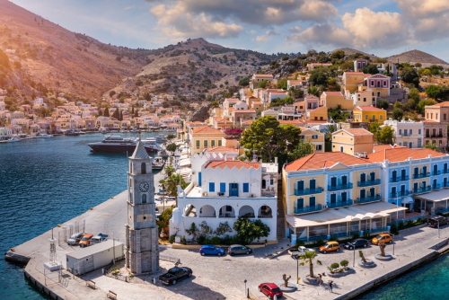 Aerial view of the beautiful Greek island of Symi (Simi) with colourful houses and small boats, Dodecanese Islands, Greece