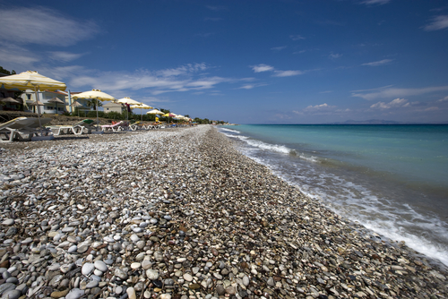 View of the pebbly beach of Ialyssos and its facilities on the West coast of the Island of Rhodes, Greece