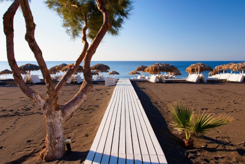 View of a black beach in the resort of Perissa and its facilities on the island of Santorini in the Aegean Sea in the South Cyclades Islands, Greece