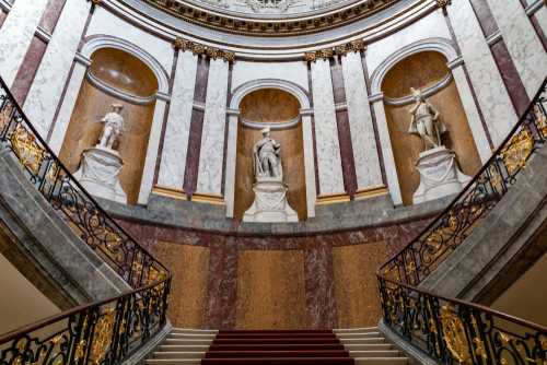 Bode Museum, an art museum in the ensemble of the Museum Island. Small domed room with rococo style stairs and marble statues in Berlin, Germany