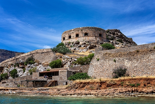Ruins and the fortress wall of the 16th century sea fortress on the island of Spinalonga in the Mediterranean Sea, gulf of Elounda near Agios Nikolaos, Island of Crete, Greece