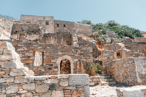 View of a fortified wall and houses of the medieval fortress on the island of Spinalonga in the Mediterranean Sea, gulf of Elounda near Agios Nikolaos, Island of Crete, Greece
