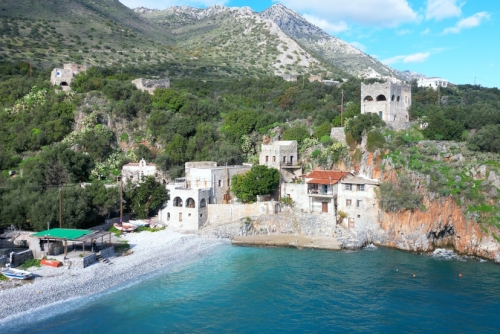 Alypa Beach, Mani Peninsula, Lakonia, Peloponnese, Greece, a beautiful stone beach with a transparent and turquoise sea water and cave in a cliff
