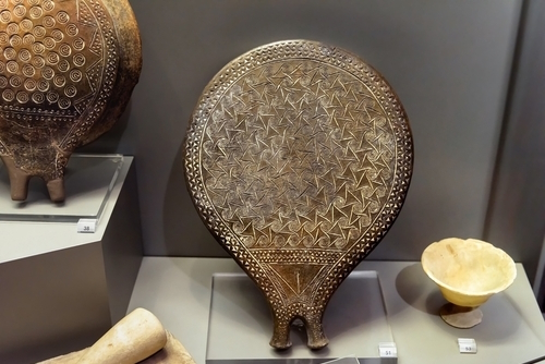 Ancient Greek pottery, so-called frying pan in the National Archaeological Museum in Athens, Greece. Old ceramic artifacts, crockery with ornament at exhibition
