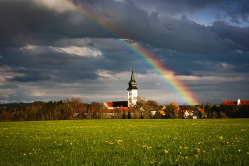 View of a beautiful rainbow and a church in Rottenbuch, Pfaffenwinkel, Upper Bavaria, Bavaria, Germany