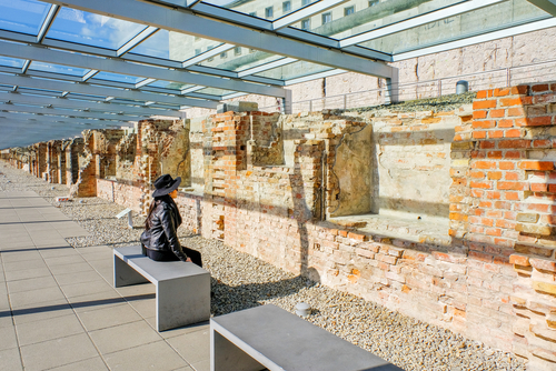 Woman looking at The wall of Topography of Terror in Berlin, Germany