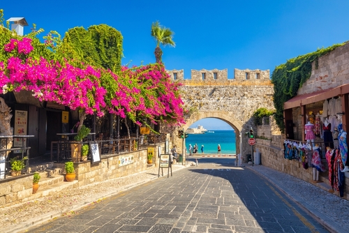 View of flowers and the gate of Virgin Mary in the historic center of the Rhodes city, Island of Rhodes, Greece