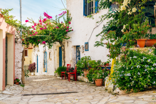 Colorful and flowery cozy street with rich greenery in Afionas village, Corfu Island, Greece