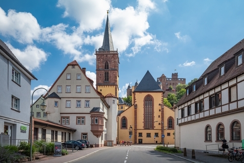View of the Collegiate church apse and bell tower in the village of Wertheim near Wurzburg, Bavaria, Germany