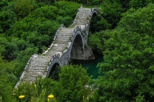View of the Plakidas three-arched bridge in Vikos Gorge National Park, Zagori, Greece