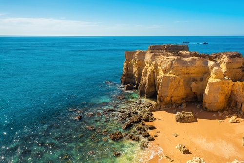 Cliff rock formations over sandy beach near Albufeira, Algarve region, Portugal, Europe. Popular touristic destination for summer vacation on Portuguese Atlantic coast to learn about in thetjoy.com