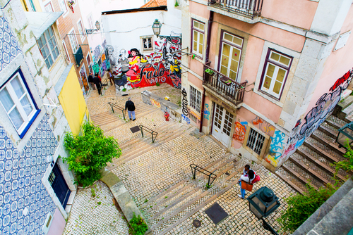 People walking on a street stairs of Lisbon in Alfama district, Portugal
