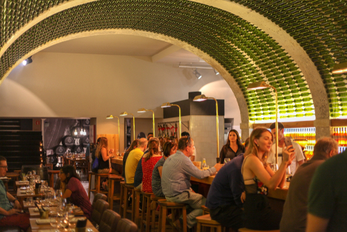 Wine Bars in the Bairro Alto in Lisbon, Portugal is a modern tavern, the ceiling is arched and lined with empty bottles, producing a tunnel