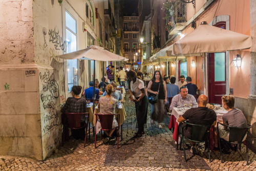 Narrow street with bars and cafes in Bairro Alto neighborhood in Lisbon, Portugal