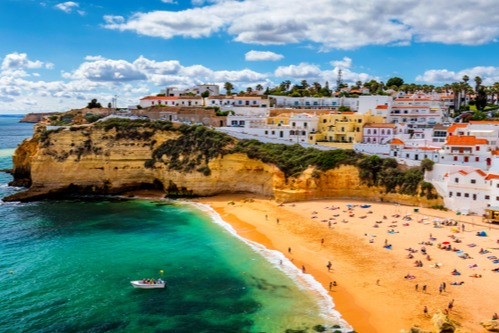 View of Carvoeiro fishing village with beautiful beach, Algarve, Portugal. Travel and enjoy Carvoeiro fishing village and beach resort and learn about its attractions in thetjoy.com